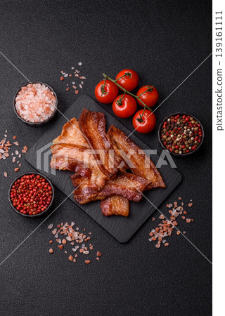Fried fresh bacon slices with layers of meat or prosciutto prepared for breakfast. Fried bacon Fried fresh bacon slices with layers of meat or prosciutto prepared for breakfast. Fried bacon 139161111