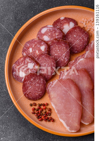 Smoked or dry cured salami slices or ham with salt and spices. Smoked sausage Smoked or dry cured salami slices or ham with salt and spices. Smoked sausage 139161116