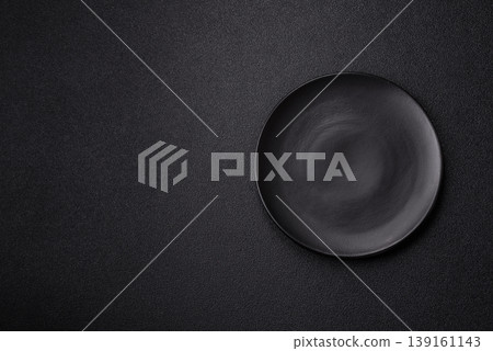 An empty ceramic round plate, kitchen utensils for a dinner table. An empty plate An empty ceramic round plate, kitchen utensils for a dinner table. An empty plate 139161143