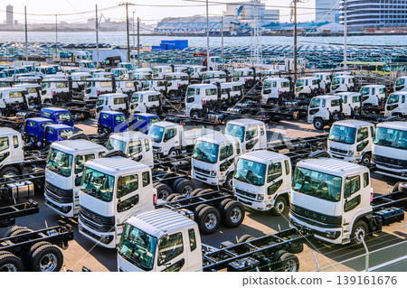 Yokohama cityscape, Japan; Japanese economy...view of trucks lined up at Daikoku Pier. Yokohama cityscape, Japan; Japanese economy...view of trucks lined up at Daikoku Pier. 139161676