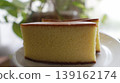 A soft and fluffy slice of castella cake served on a white plate. 139162174