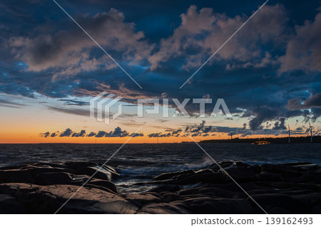 Sunset colours, clouds and rocks on the shore of the Baltic sea, Pori, Finland 139162493