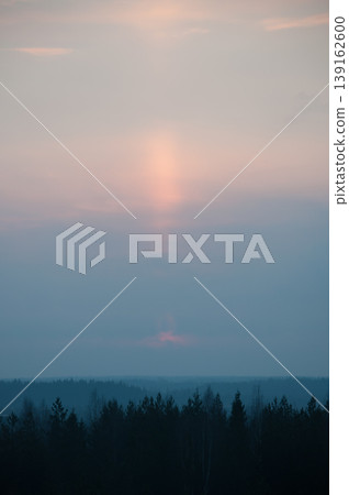 Early morning sunlight showing behind clouds over Finnish forest wilderness 139162600