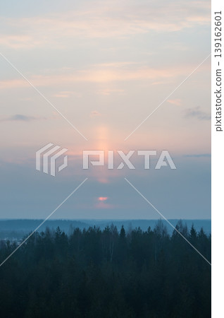 Early morning sunlight showing behind clouds over Finnish forest wilderness 139162601
