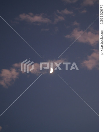 A crescent moon floats in the twilight sky. A crescent moon floats in the twilight sky. 139162673