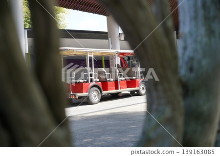 Red Shuttle Bus Seen Through Tree Branches Red Shuttle Bus Seen Through Tree Branches 139163085