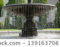 The fountain's spray, sparkling in the summer sun, and the classic beauty of its stonework. 139163708