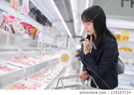 一位女商人正在超市挑選肉類。 一位女商人正在超市挑選肉類。 139163724