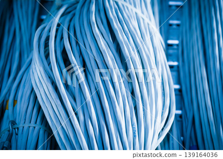 bunch of network cables in wave pattern leading across server ro bunch of network cables in wave pattern leading across server ro 139164036