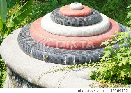 Colorful Circular Garden Structure Surrounded by Greenery 139164152