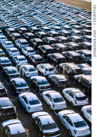 The urban landscape of Yokohama, Japan; the US-Japan global economy…view of cars lined up at Daikoku Pier. Towards a brighter era. The urban landscape of Yokohama, Japan; the US-Japan global economy…view of cars lined up at Daikoku Pier. Towards a brighter era. 139164582