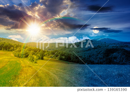 day meet night in beautiful countryside. epic view landscape in mountains on summer solstice. sun and moon in harmony over trail through the grassy field near forested rolling hills. rural scenery day meet night in beautiful countryside. epic view landscape in mountains on summer solstice. sun and moon in harmony over trail through the grassy field near forested rolling hills. rural scenery 139165390
