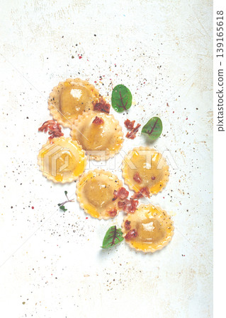 fresh ravioli, with butter, spices and herbs, fried bacon, on the table, top view, light background, no people, 139165618