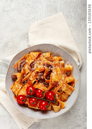 pappardelle pasta with bolognese sauce, topped with parmesan cheese and cherry branch, homemade, no people, 139165636