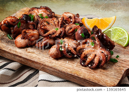 grilled baby octopus,with green onions, with lemon wedges, on a wooden chopping board, homemade, no people, 139165645