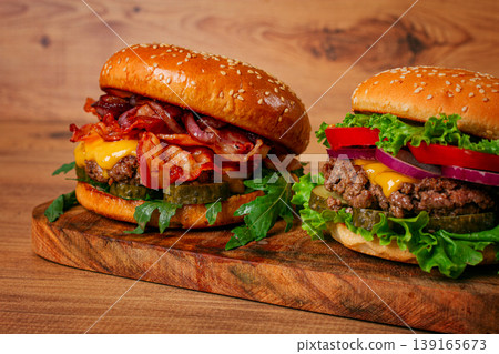 two burgers with beef patty, fried bacon, cheddar cheese, tomatoes, homemade, no people, two burgers with beef patty, fried bacon, cheddar cheese, tomatoes, homemade, no people, 139165673