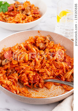 Bigos, Polish dish bigos, on the table, pan with stewed meat, with cabbage, chorizo sausages, mushrooms, homemade, without people, Bigos, Polish dish bigos, on the table, pan with stewed meat, with cabbage, chorizo sausages, mushrooms, homemade, without people, 139165686