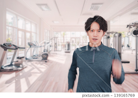 A young man working out at the gym A young man working out at the gym 139165769