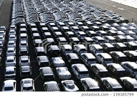 The urban landscape of Yokohama, Japan; the US-Japan global economy…view of cars lined up at Daikoku Pier. Towards a new era. The urban landscape of Yokohama, Japan; the US-Japan global economy…view of cars lined up at Daikoku Pier. Towards a new era. 139165794