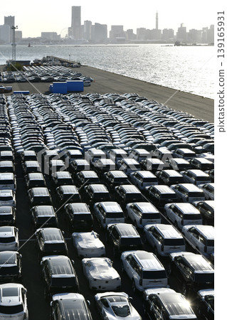 The urban landscape of Yokohama, Japan; the US-Japan global economy…view of cars lined up at Daikoku Pier. Towards a brighter era. The urban landscape of Yokohama, Japan; the US-Japan global economy…view of cars lined up at Daikoku Pier. Towards a brighter era. 139165931