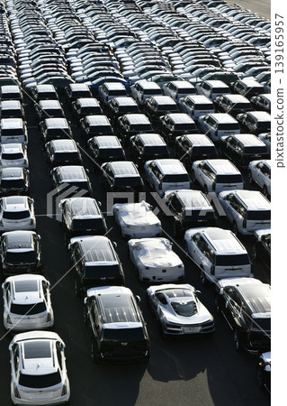 The urban landscape of Yokohama, Japan; the US-Japan global economy…view of cars lined up at Daikoku Pier. Towards a new era. The urban landscape of Yokohama, Japan; the US-Japan global economy…view of cars lined up at Daikoku Pier. Towards a new era. 139165957