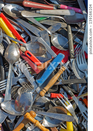 Silver metal and plastic cutlery pile Silver metal and plastic cutlery pile 139166104