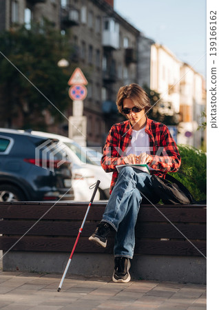Blind young guy is in the town outdoors Blind young guy is in the town outdoors 139166162