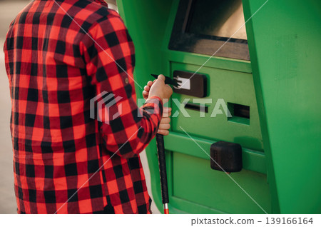 Close up view of man with white cane by the ATM using credit card 139166164