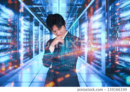 A young man working in the server room 139166199