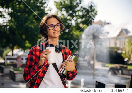 Feeling good, walking. Young student is outdoors at daytime Feeling good, walking. Young student is outdoors at daytime 139166225