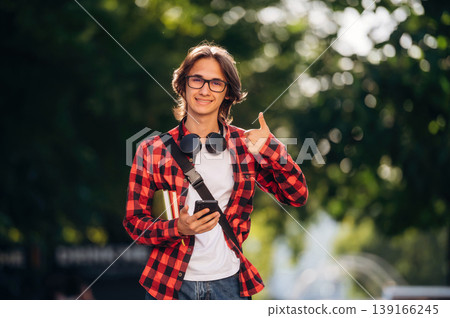 Happy young student is having a walk in the town Happy young student is having a walk in the town 139166245