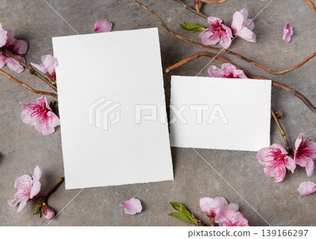Blank cards set mockup with pink cherry blossoms and twigs on grey stone. Spring wedding stationery 139166297