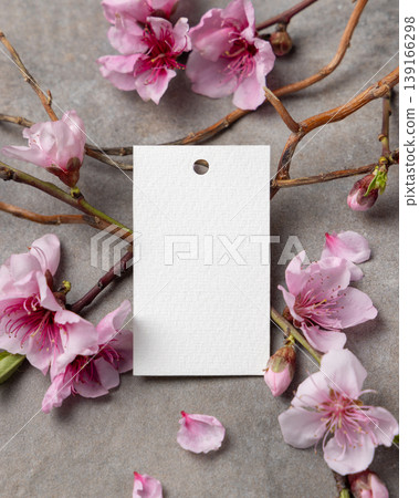Blank vertical gift tag mockup with pink spring flowers and wooden twigs on grey stone, label design Blank vertical gift tag mockup with pink spring flowers and wooden twigs on grey stone, label design 139166298