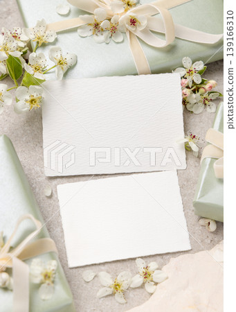 Double sided cards mockup with white spring flowers and driftwood on beige stone. Wedding invitation Double sided cards mockup with white spring flowers and driftwood on beige stone. Wedding invitation 139166310