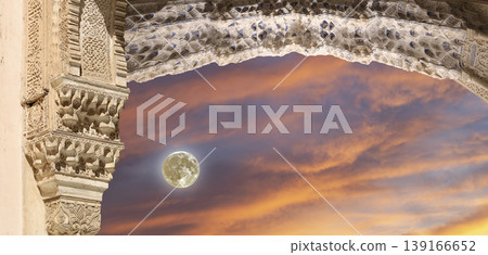 Arches in Islamic (Moorish) style (against the sunset with the super moon) in Alhambra, Granada, Spain Arches in Islamic (Moorish) style (against the sunset with the super moon) in Alhambra, Granada, Spain 139166652