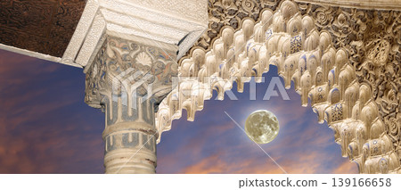 Arches in Islamic (Moorish) style (against the sunset with the super moon) in Alhambra, Granada, Spain Arches in Islamic (Moorish) style (against the sunset with the super moon) in Alhambra, Granada, Spain 139166658