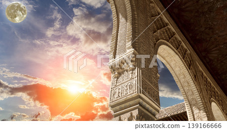 Arches in Islamic (Moorish) style (against the sunset with the super moon) in Alhambra, Granada, Spain Arches in Islamic (Moorish) style (against the sunset with the super moon) in Alhambra, Granada, Spain 139166666