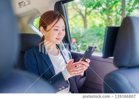 一位職業婦女微笑著坐進計程車。 139166807