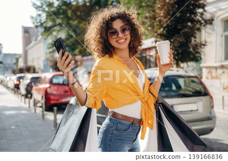 Wellbeing and leisure conception. Happy woman is with shopping bags in town 139166836