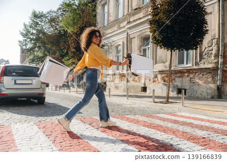 Pretty and happy. Cheerful woman is with shopping bags in town Pretty and happy. Cheerful woman is with shopping bags in town 139166839
