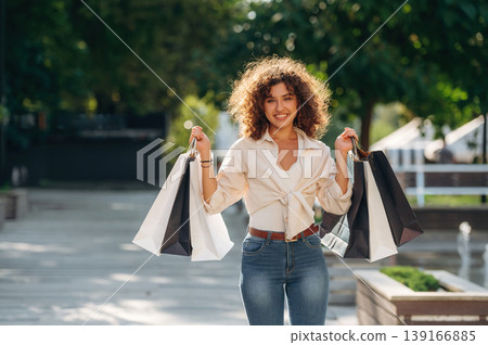 Gorgeous happy woman is with shopping bags in town Gorgeous happy woman is with shopping bags in town 139166885