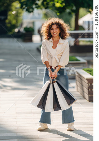 Gorgeous happy woman is with shopping bags in town 139166886