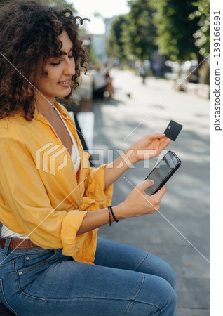 Online shopping. Woman is using smartphone and credit card to buy online 139166891