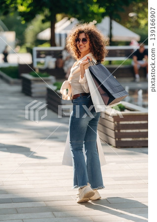 Weekend activities conception. Happy woman is with shopping bags in town 139166907
