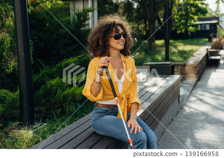 A blind woman is in the modern city at daytime A blind woman is in the modern city at daytime 139166958