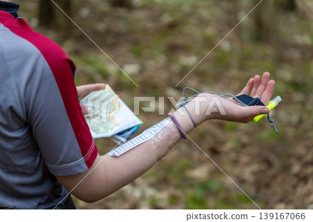 an orienteer checks the map against the legend 139167066