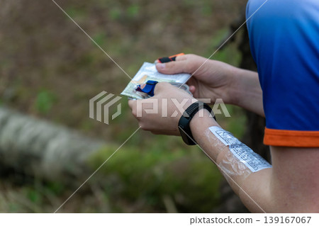 an orienteer hands reviewing a detailed orienteering course map an orienteer hands reviewing a detailed orienteering course map 139167067