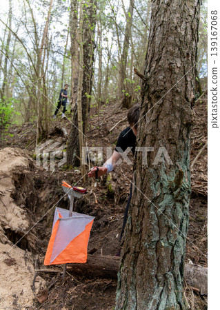 Orienteering control point with orange and white flag Orienteering control point with orange and white flag 139167068