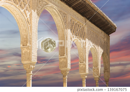Arches in Islamic (Moorish) style (against the sunset with the super moon) in Alhambra, Granada, Spain Arches in Islamic (Moorish) style (against the sunset with the super moon) in Alhambra, Granada, Spain 139167075