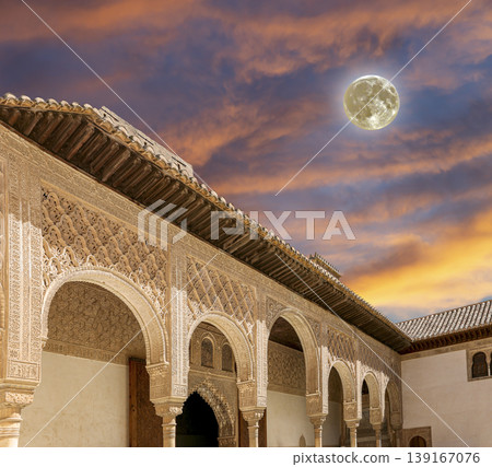 Arches in Islamic (Moorish) style (against the sunset with the super moon) in Alhambra, Granada, Spain Arches in Islamic (Moorish) style (against the sunset with the super moon) in Alhambra, Granada, Spain 139167076